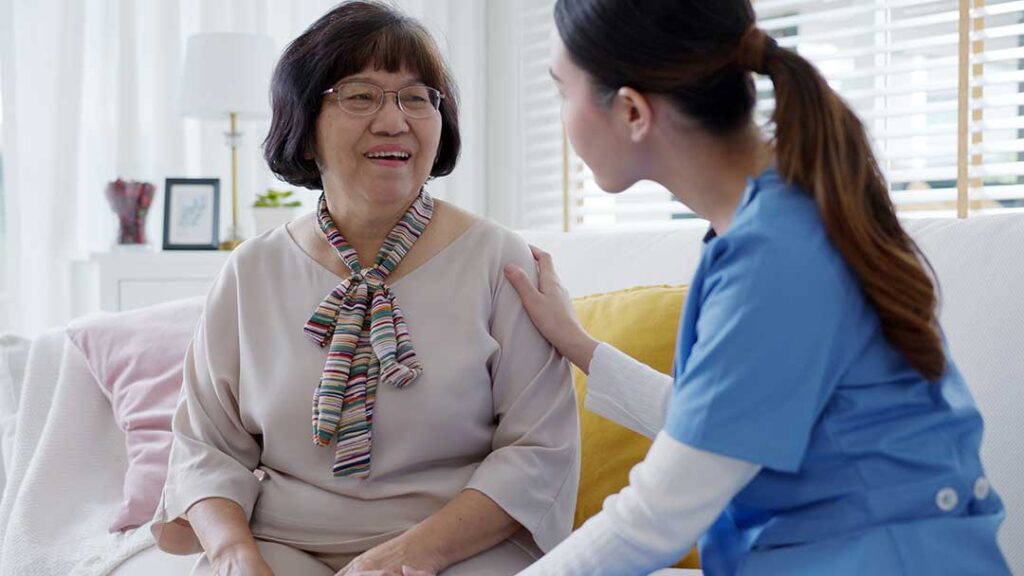 A warmly decorated assisted living apartment with family photos, cozy blankets, and cherished keepsakes on display.